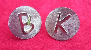 Golf markers bearing the initials B and K