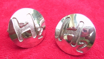 Domed cufflinks both with letter H