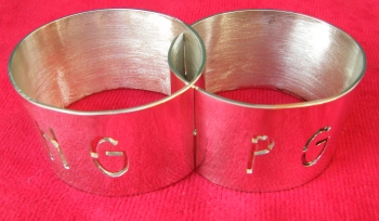 Joined napkin rings with initials