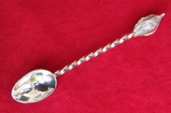 Spoon with twisted handle and plum stone finial